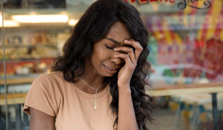 A woman with burnout crying